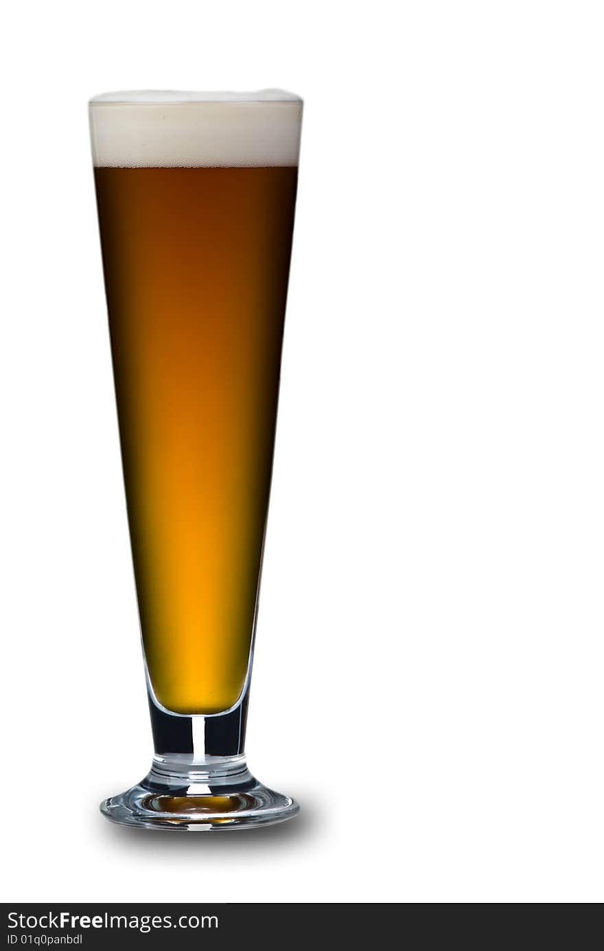 A close up of a single glass of beer on a white background. Beer is a lovely golden colour with white frothy bubbles on top.