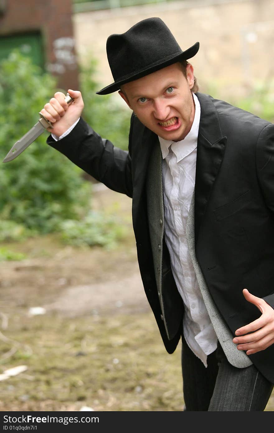 Angry man holding hunting knife on the street. Angry man holding hunting knife on the street