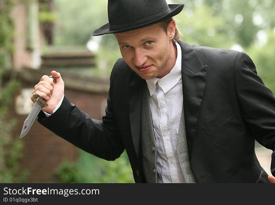 Angry Man in hat holding hunting knife. Angry Man in hat holding hunting knife