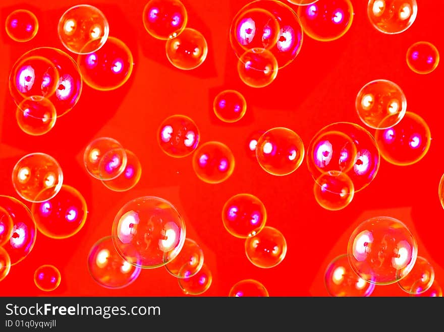 Soap bubbles isolated on red background