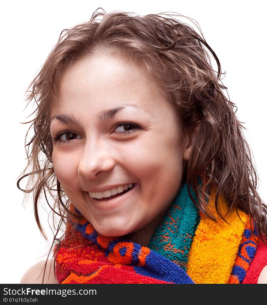 Beautiful girl with wet hair smiles in colour towel, on white background. Beautiful girl with wet hair smiles in colour towel, on white background