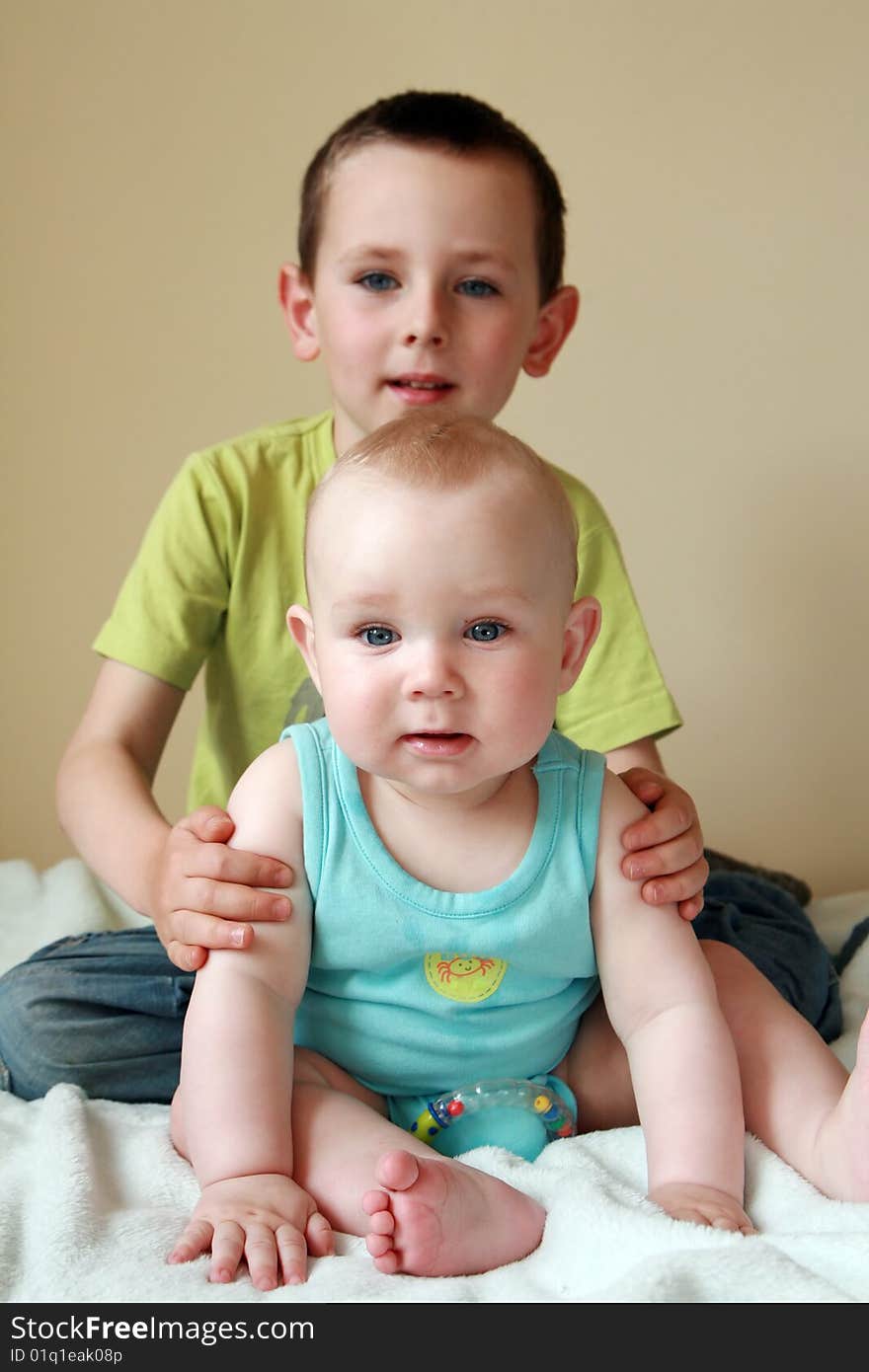 Portrait of two brothers. 7 months old baby boy and 5 years old preschooler. Kids smiling and having fun. Portrait of two brothers. 7 months old baby boy and 5 years old preschooler. Kids smiling and having fun.