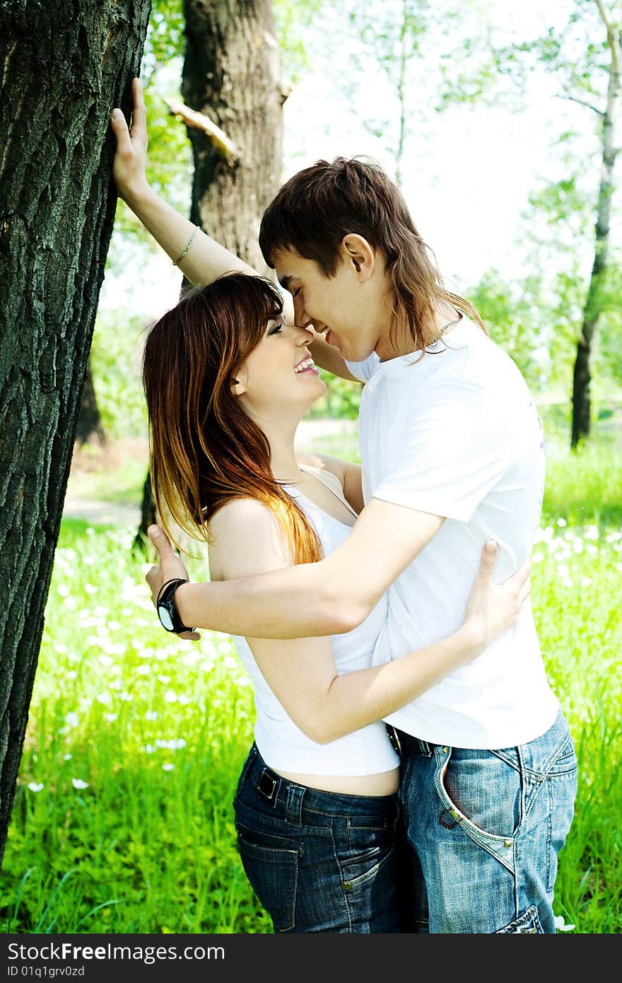 Happy young couple spending time in summer park