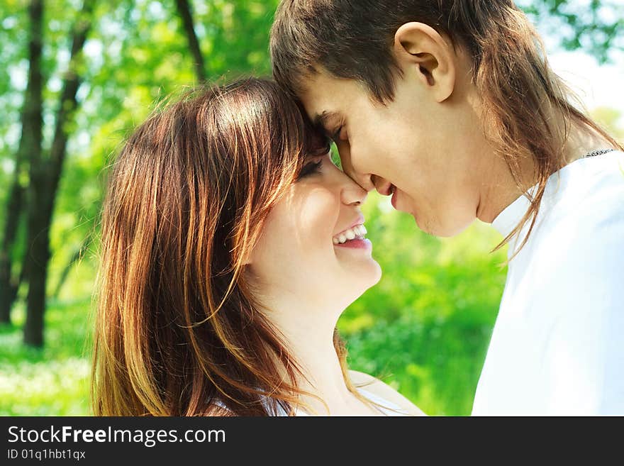 Happy young couple spending time in summer park. Happy young couple spending time in summer park