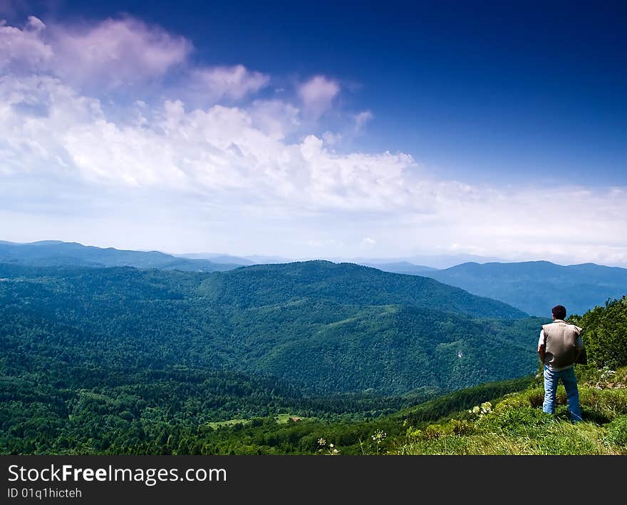 Man on the mountain enjoying scenery. Man on the mountain enjoying scenery.