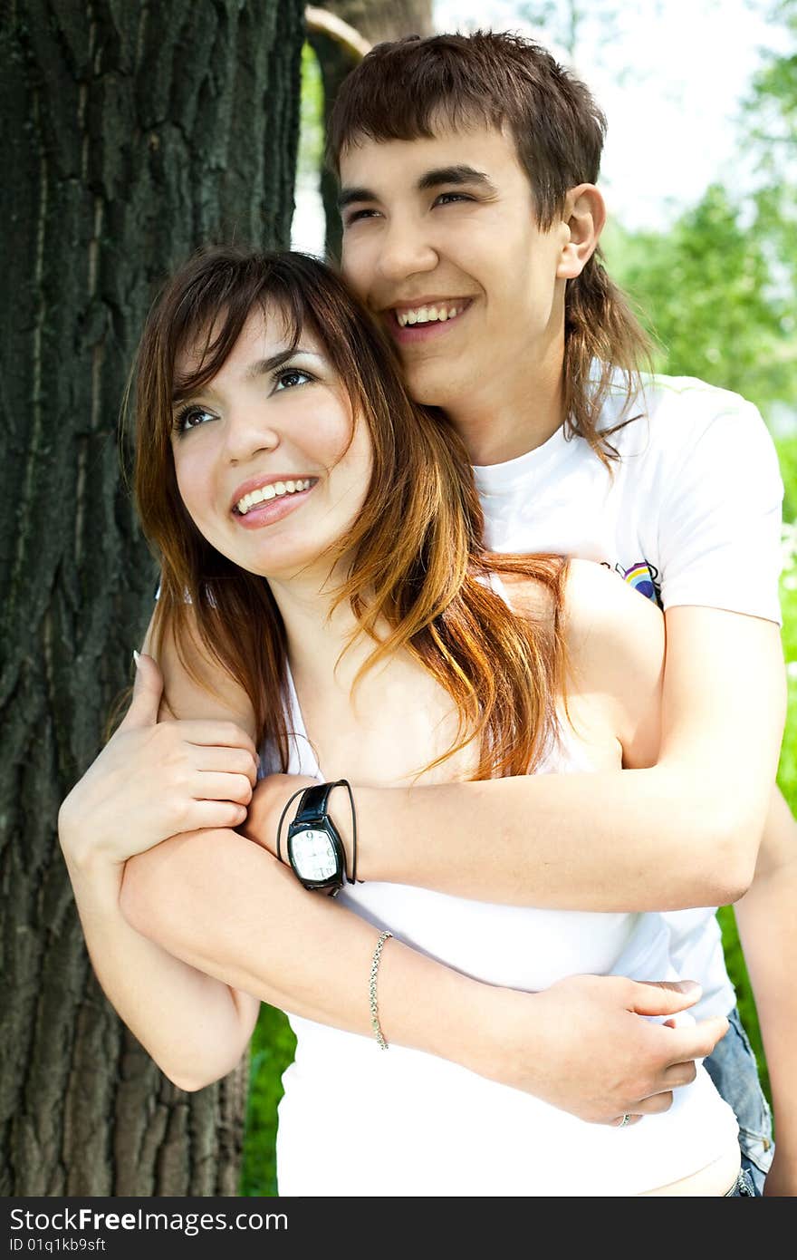 Happy young couple spending time in summer park. Happy young couple spending time in summer park