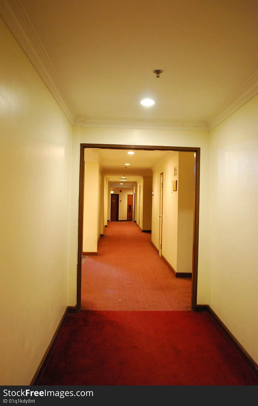 Walkway within a hotel with red carpet