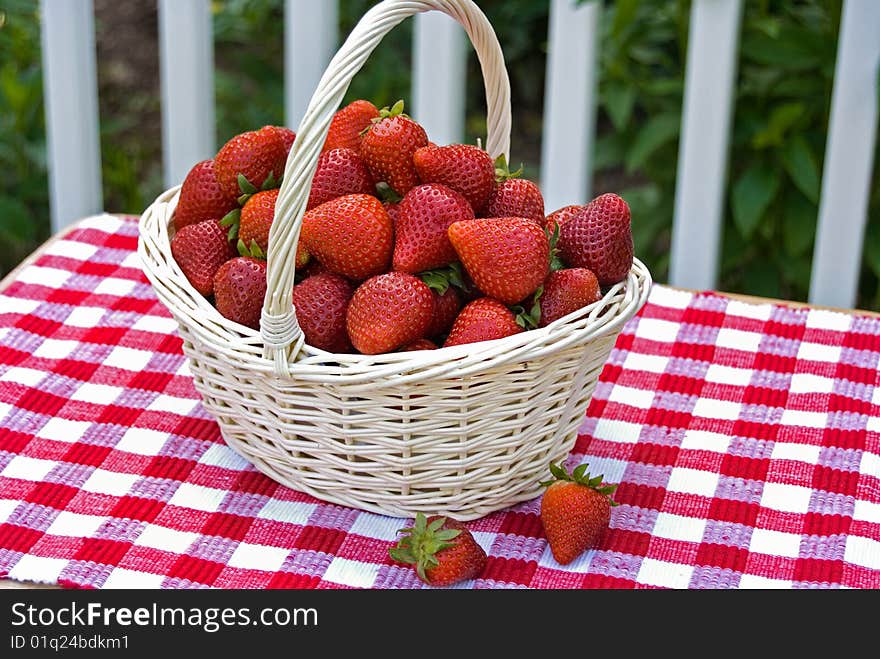 Summer strawberries in a wicker basket. Summer strawberries in a wicker basket.