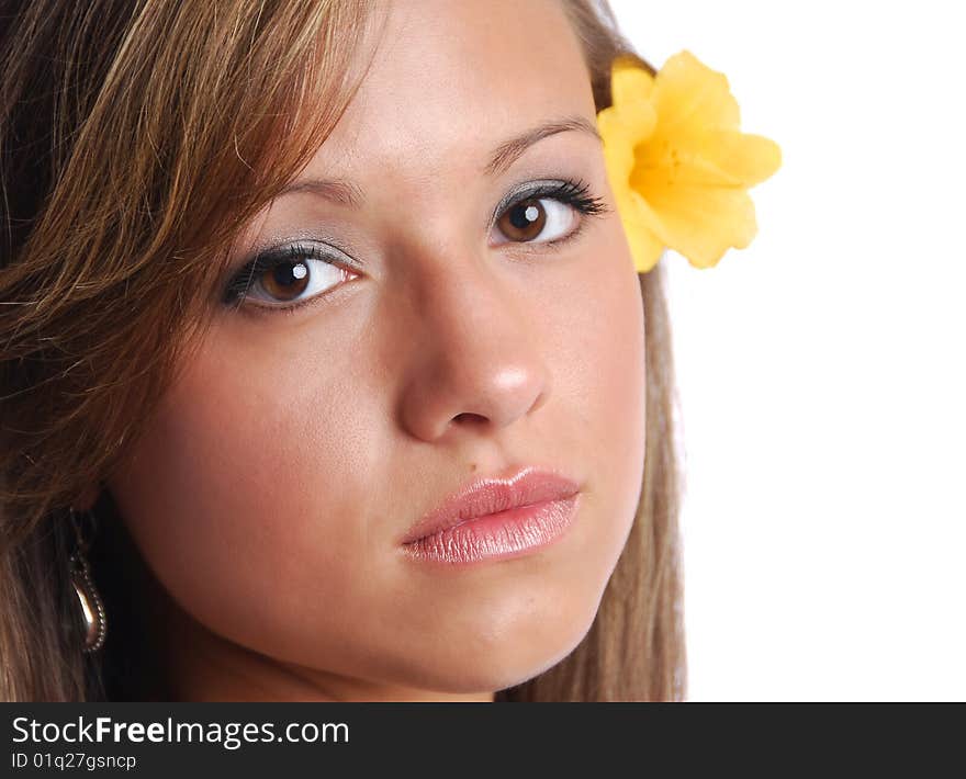 Closeup of a pretty girl's face with a yellow flower. Closeup of a pretty girl's face with a yellow flower.