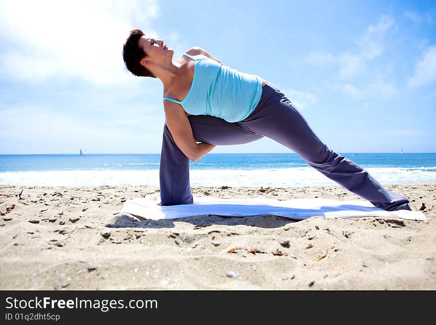 Yoga on the Beach doing a sideways bend