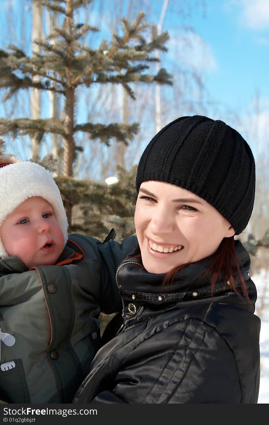 Portrait of young mum with the son in the winter on walk. Portrait of young mum with the son in the winter on walk