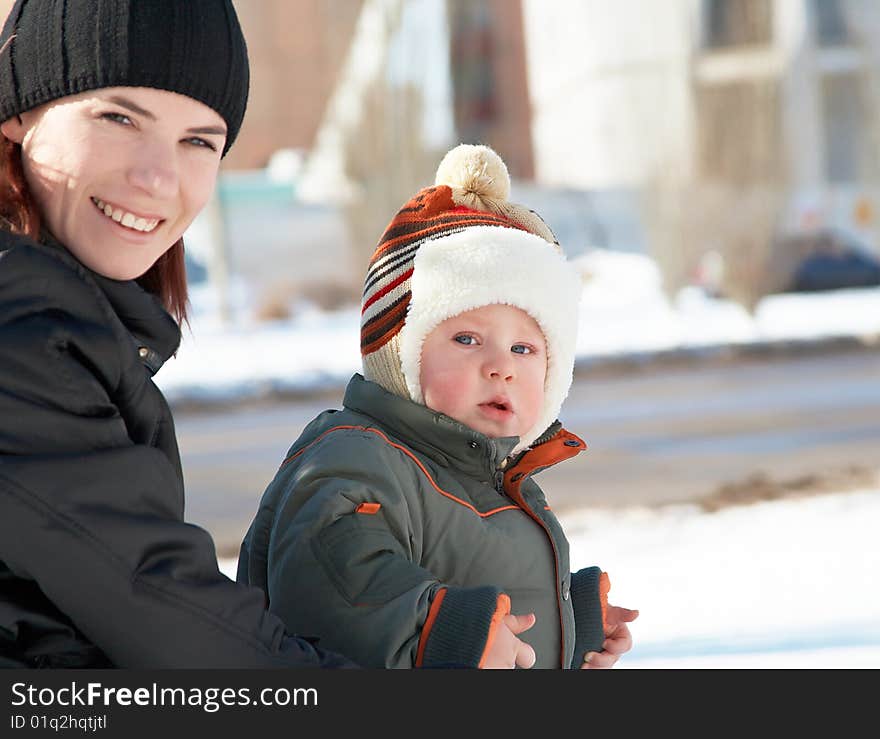 Portrait of young mum with the son in the winter on walk. Portrait of young mum with the son in the winter on walk