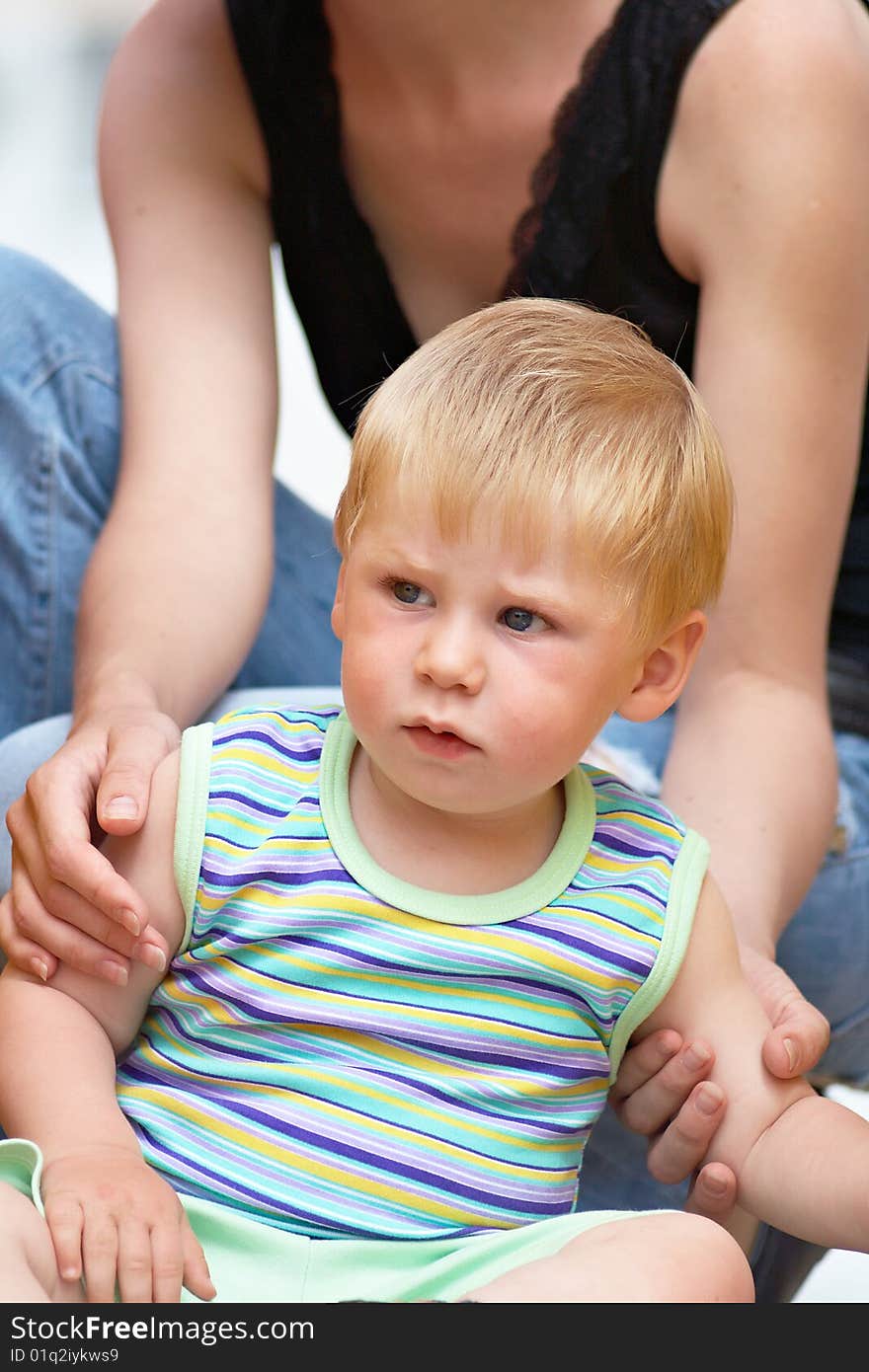 Woman and young boy outdoors embracing. Woman and young boy outdoors embracing