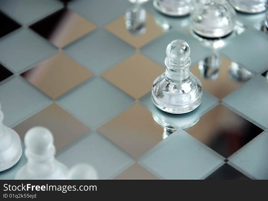 Glass chessboard with first beginning position of pawn