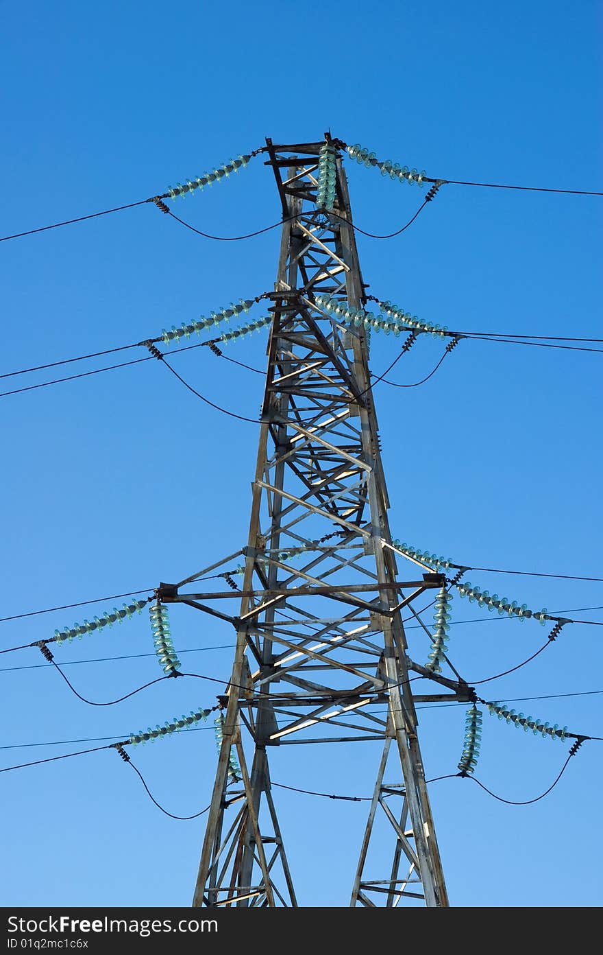 High-voltage line electrified  on background blue sky. High-voltage line electrified  on background blue sky