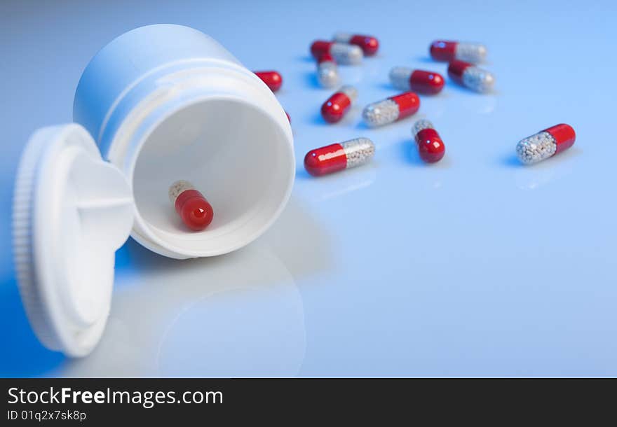 Tablets and a jar on a blue background. Tablets and a jar on a blue background