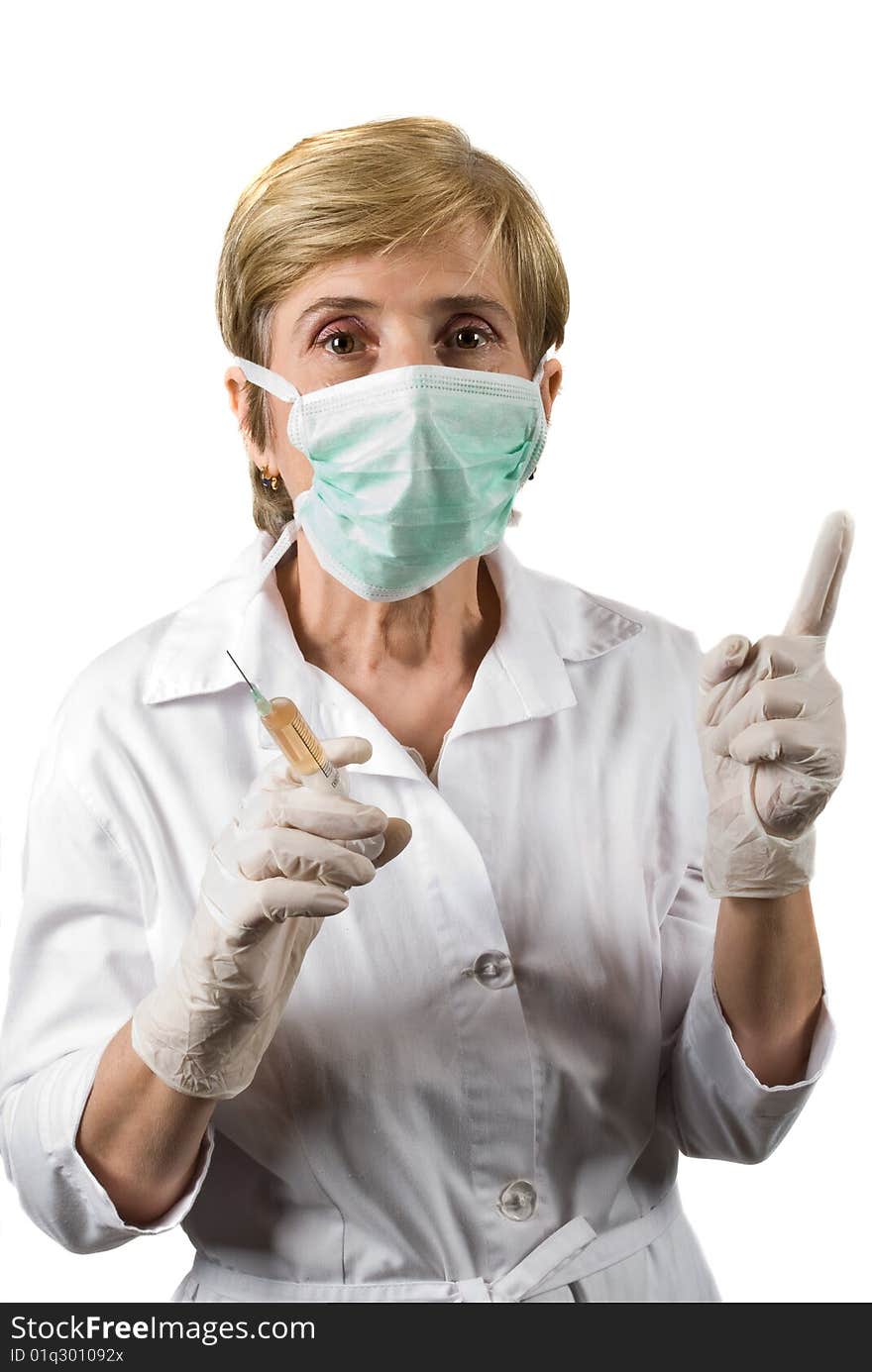 Mature woman doctor wearing protective mask , holding a syringe and pointing upwards to copy space isolated on white background,check also Medical. Mature woman doctor wearing protective mask , holding a syringe and pointing upwards to copy space isolated on white background,check also Medical