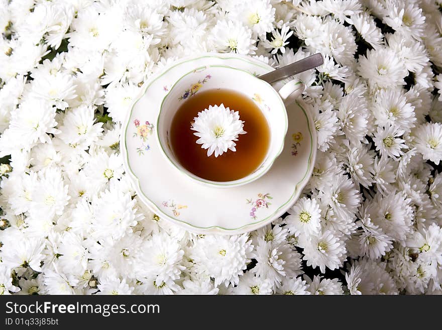 Cup of tea in flowers surrounding