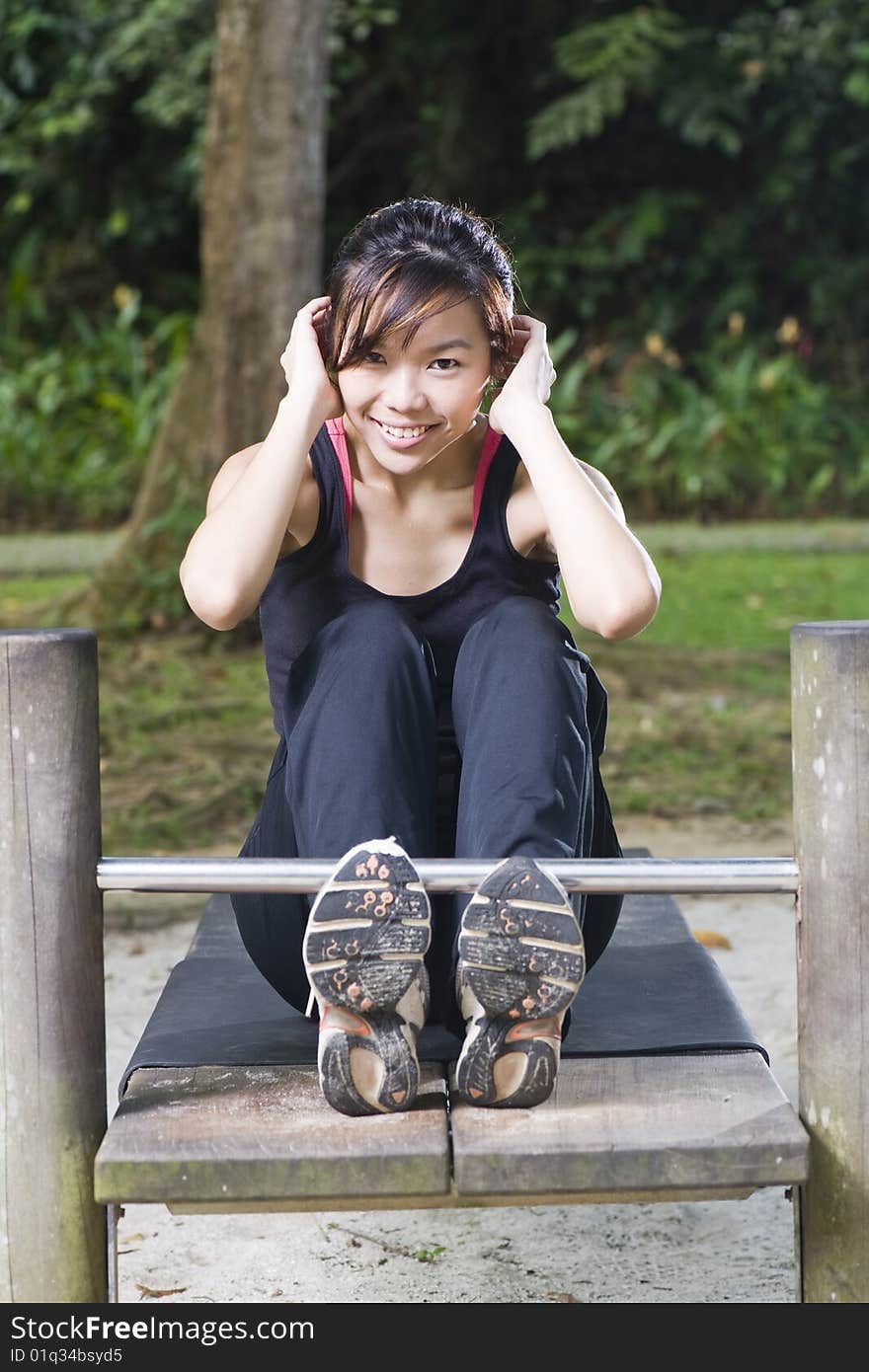 Fit asian female doing exercise