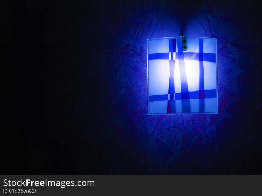 Modern blue lamp over dark background. Modern blue lamp over dark background