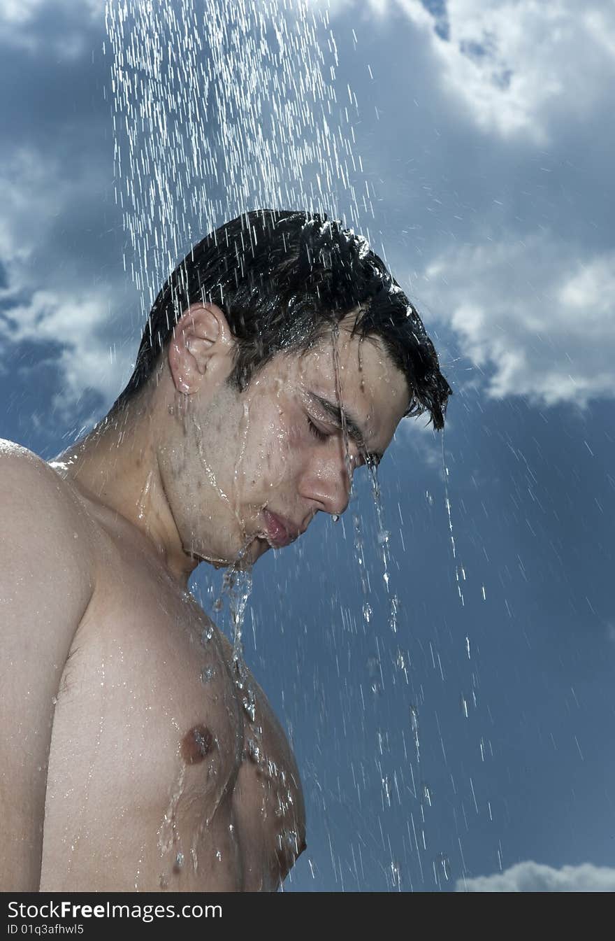 Man under outdoor shower