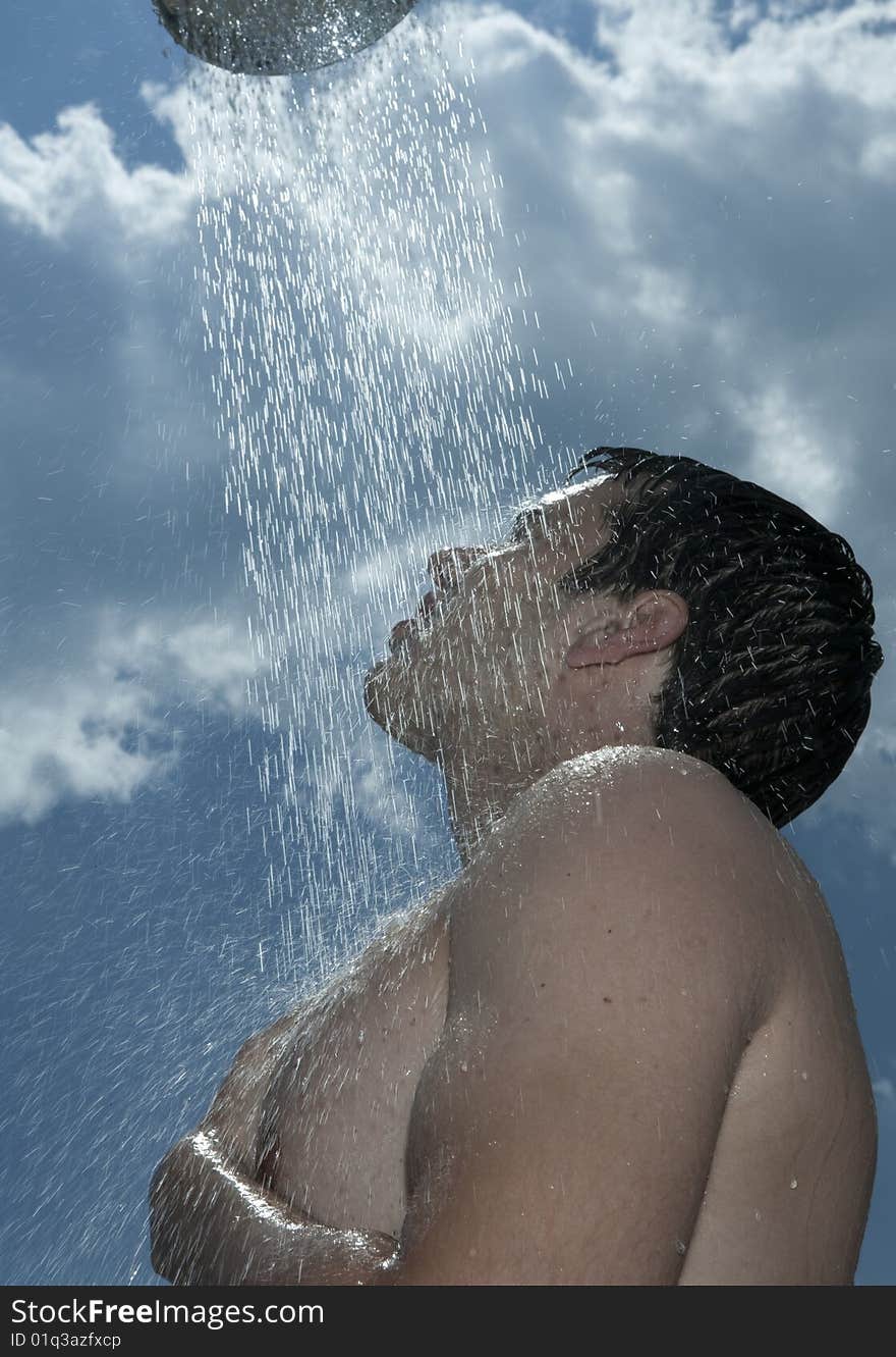 Man under outdoor shower