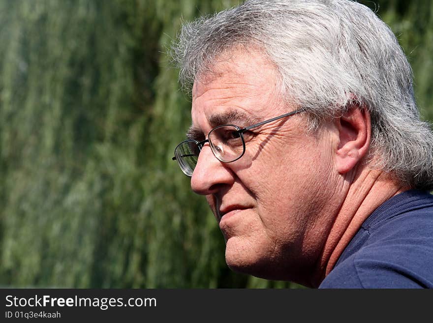 Baby boomer man smiling with gray hair and glasses