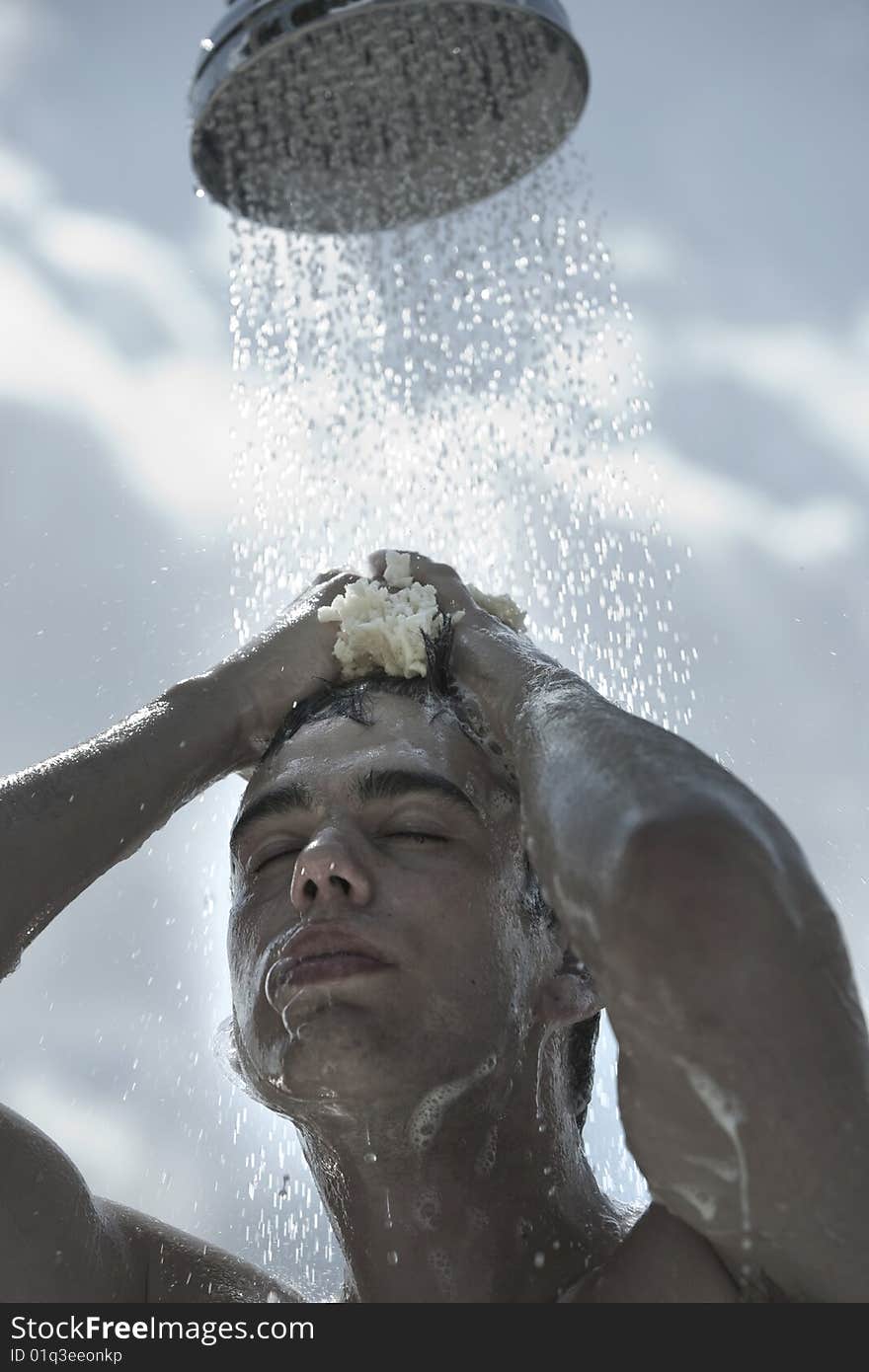 Man under outdoor shower