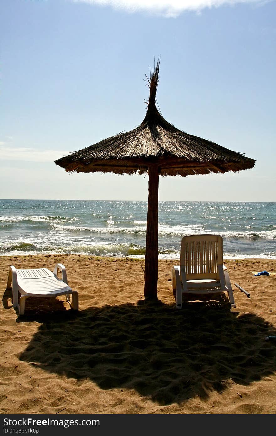 Umbrella with sunbeds on the beach. Umbrella with sunbeds on the beach