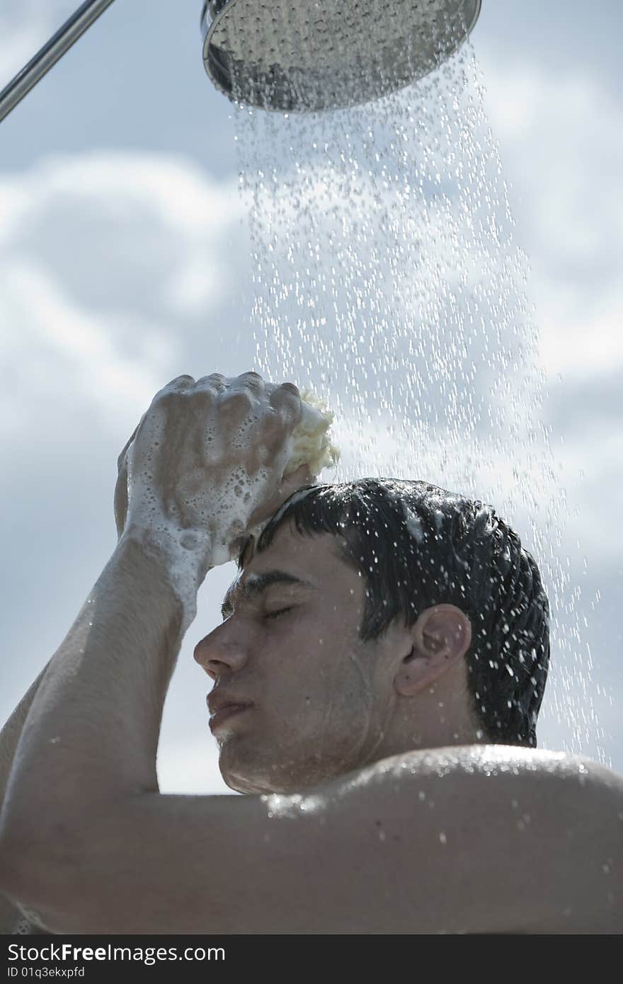 Man under outdoor shower