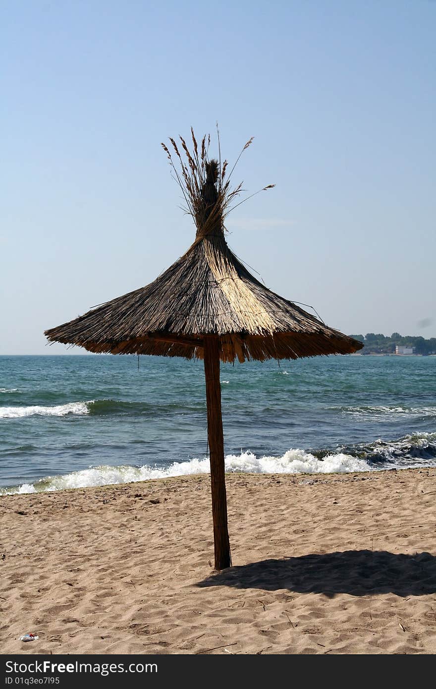 Umbrella on the beach against blue sky. Umbrella on the beach against blue sky