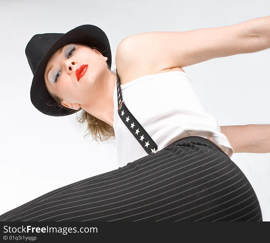 Photo-session in studio of the young blondy girl with black hat