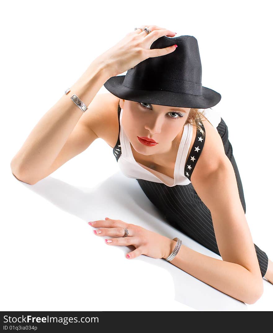 Photo-session in studio of the young blondy girl with black hat