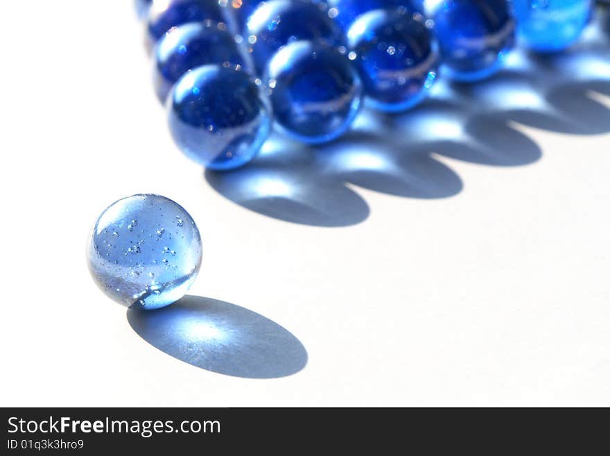 Game of billiards made from blue glass balls isolated on white background. Game of billiards made from blue glass balls isolated on white background