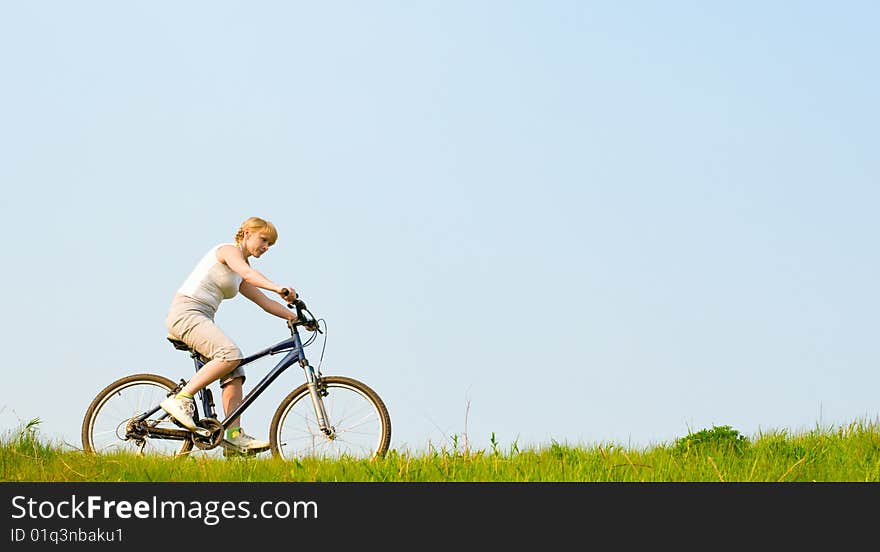 Girl relax biking on green grass