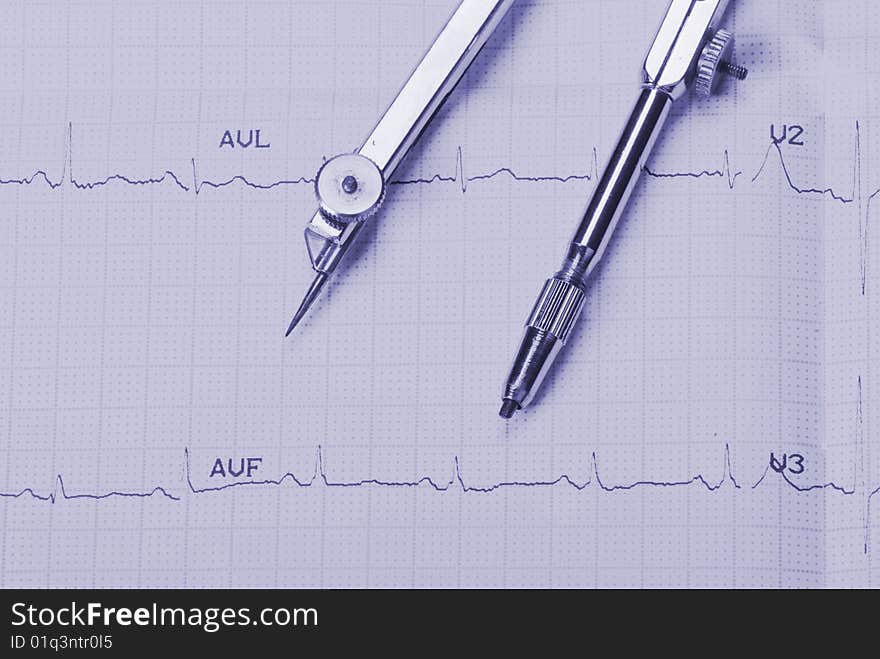 EKG printout and compasses under  monochromatic source