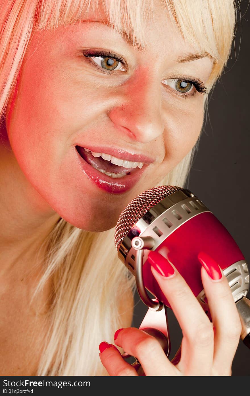 Young long hair blonde woman sing to retro microphone. Young long hair blonde woman sing to retro microphone