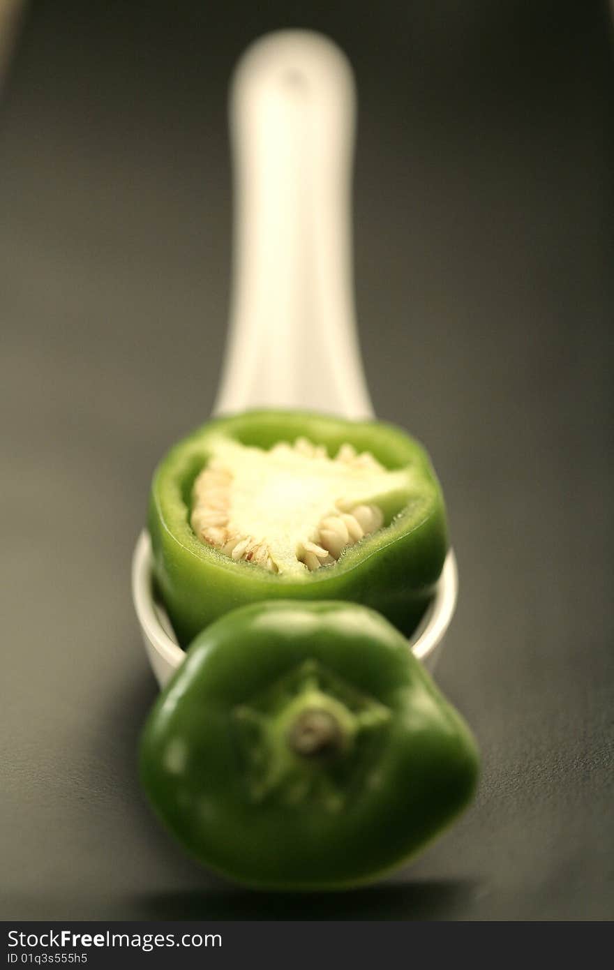 Closeup colored peppers on black plate