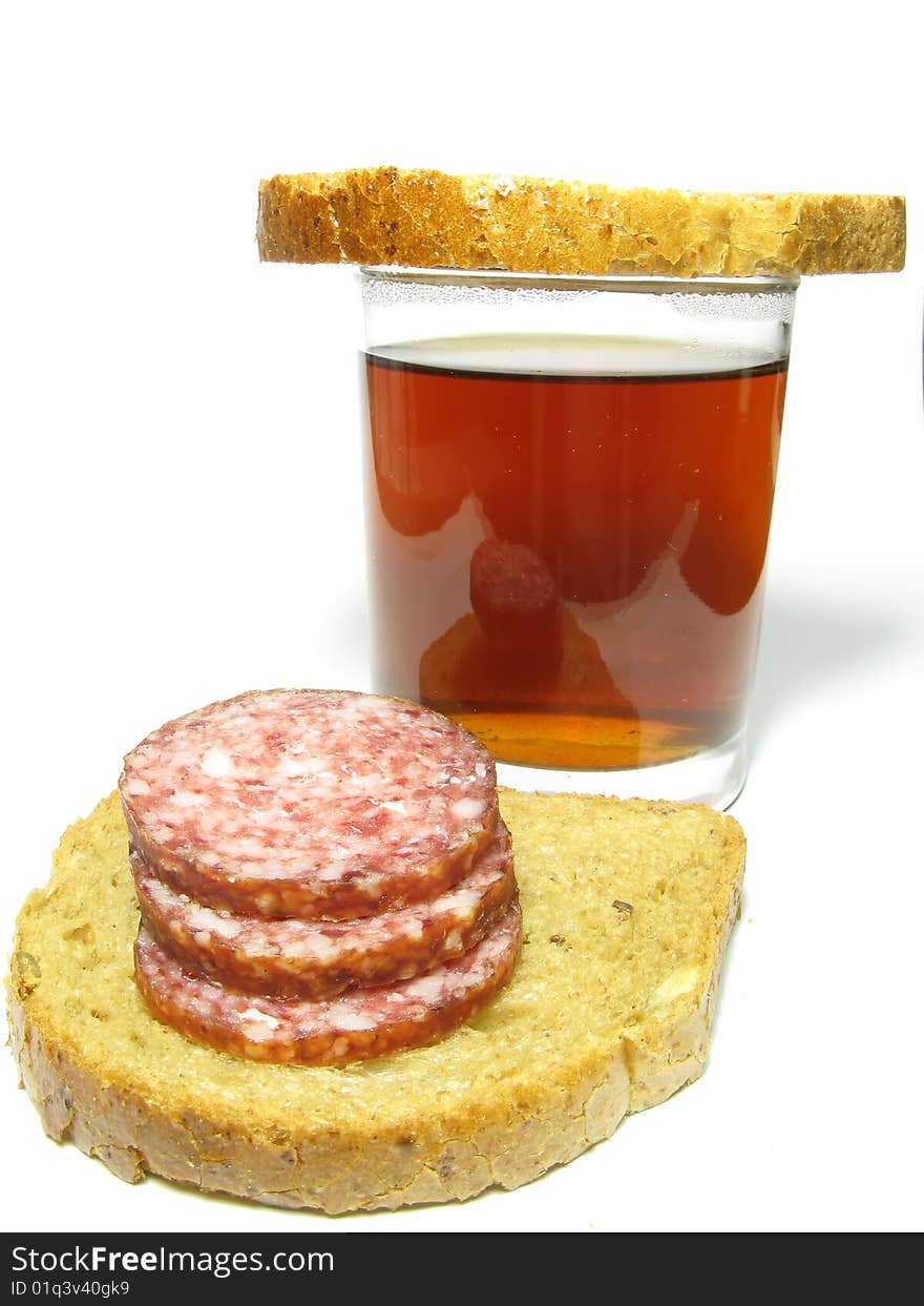 Fast food, a cup of tea and a sandwich with sausage on a white background. Fast food, a cup of tea and a sandwich with sausage on a white background.