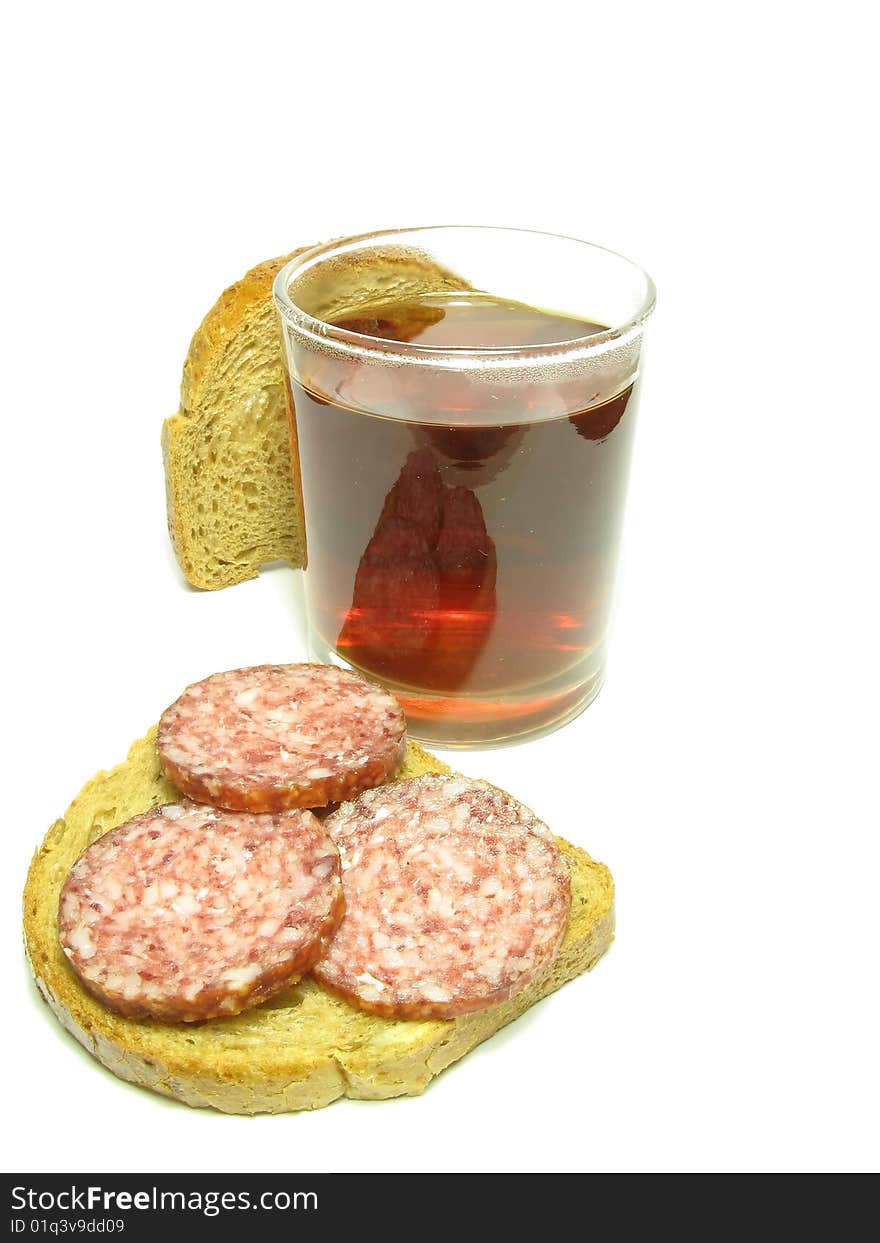 Fast food, a cup of tea and a sandwich with sausage on a white background. Fast food, a cup of tea and a sandwich with sausage on a white background.