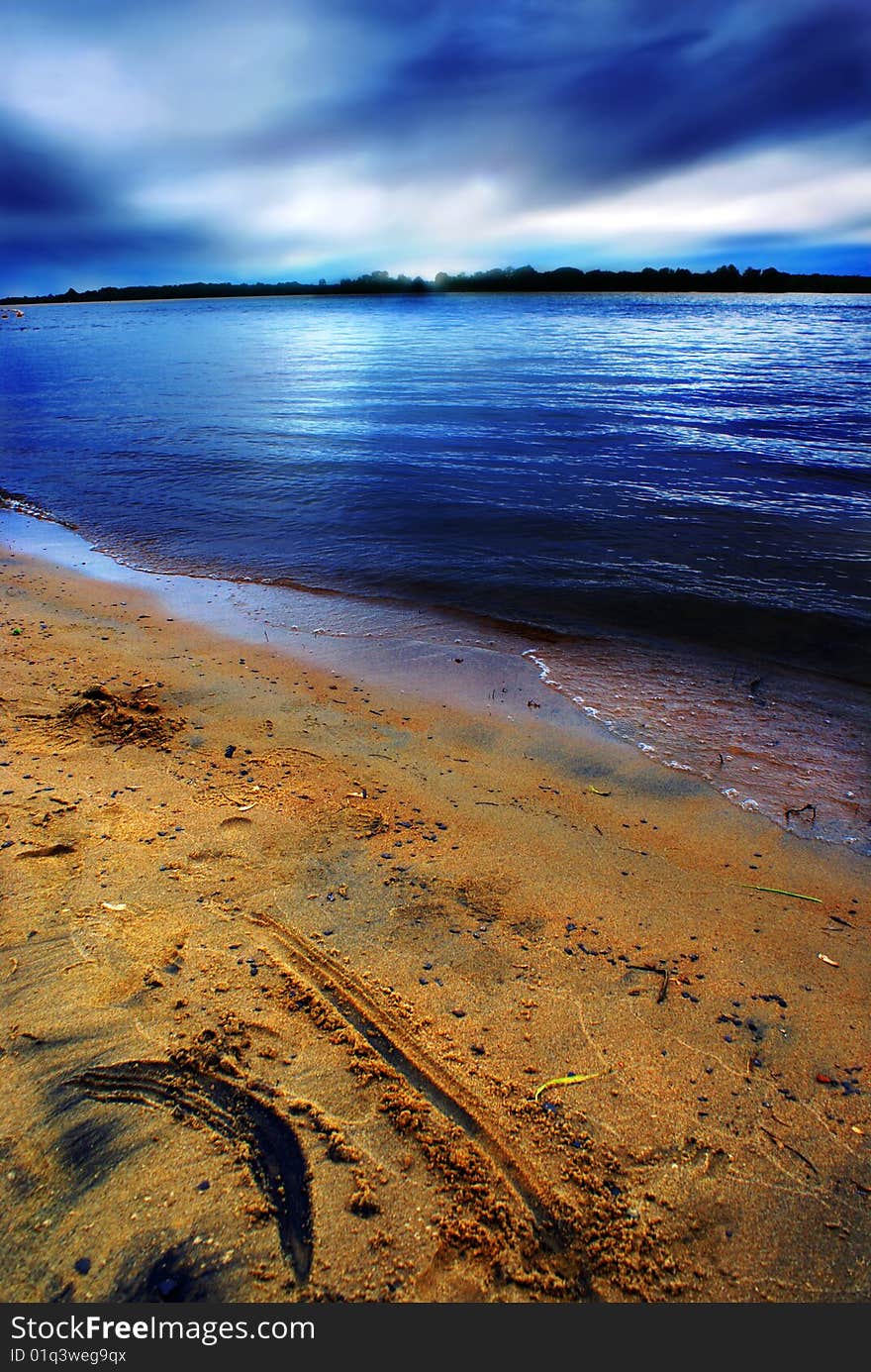 Menacing skies hover above the beach at Petrie Island