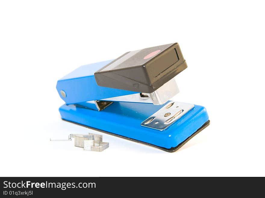 Single blue,chrome and black stapler with staples on a white background