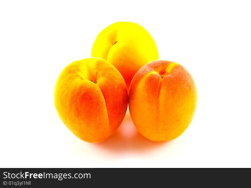 Three apricots on a white background with clipping path