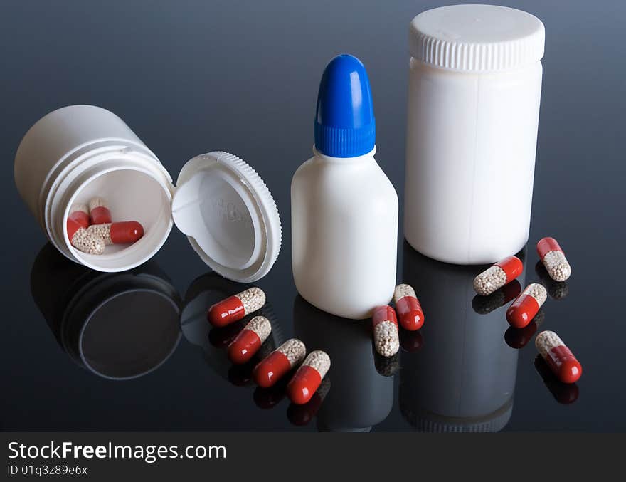 Tablets and jars against a dark background. Tablets and jars against a dark background