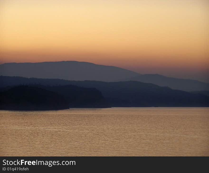 Landscape at sunset with reflection in sea water. Landscape at sunset with reflection in sea water.