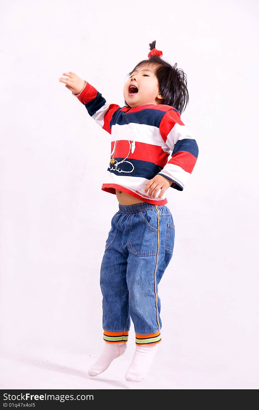 Picture of a little chinese girl with pigtail jumping for fun