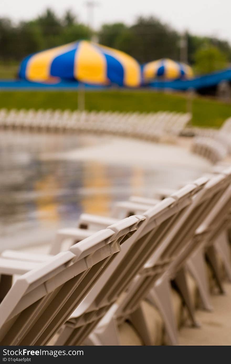 Lounge chairs lined up next to the pool. Lounge chairs lined up next to the pool.