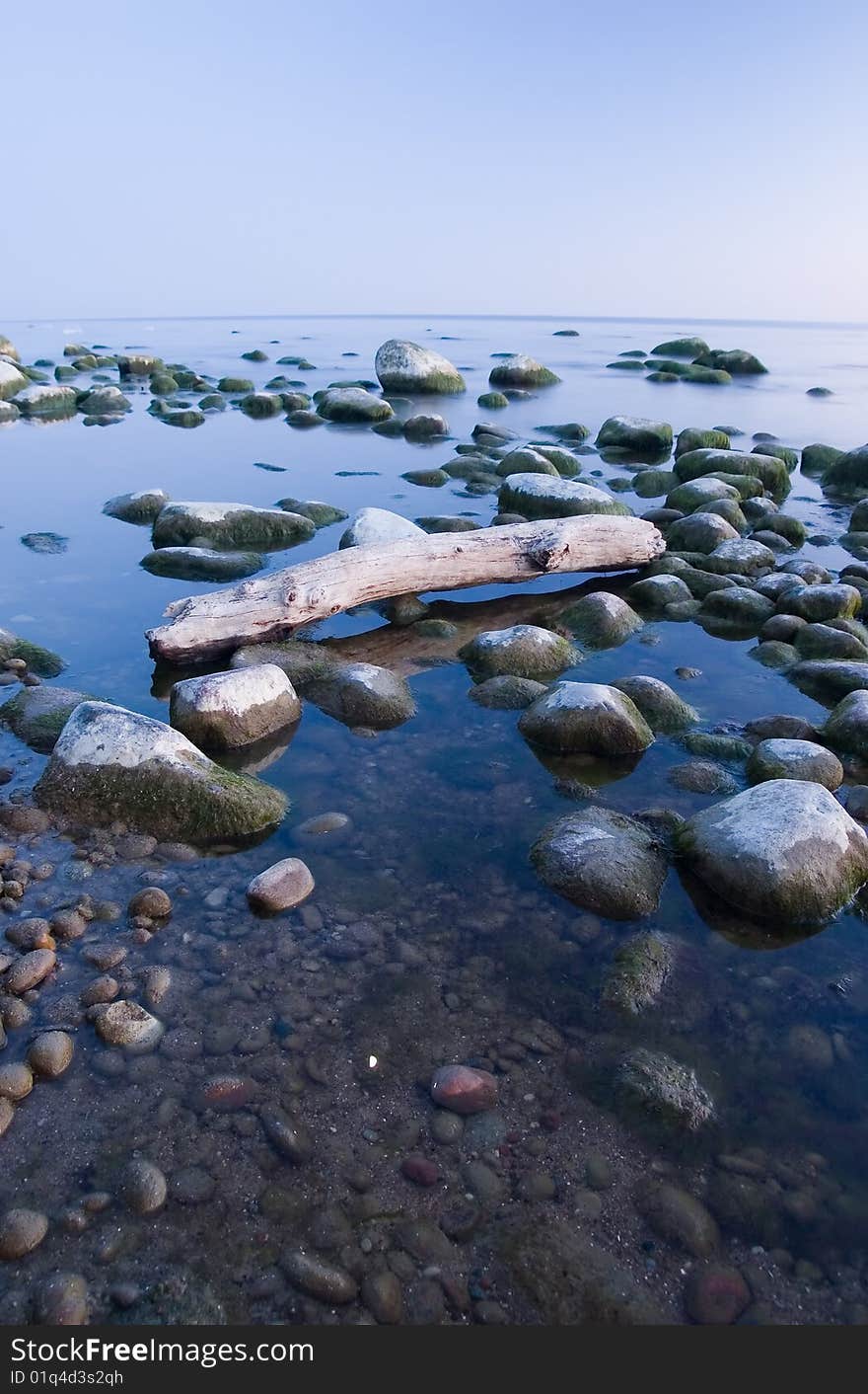 Baltic seaside with stones after sunset