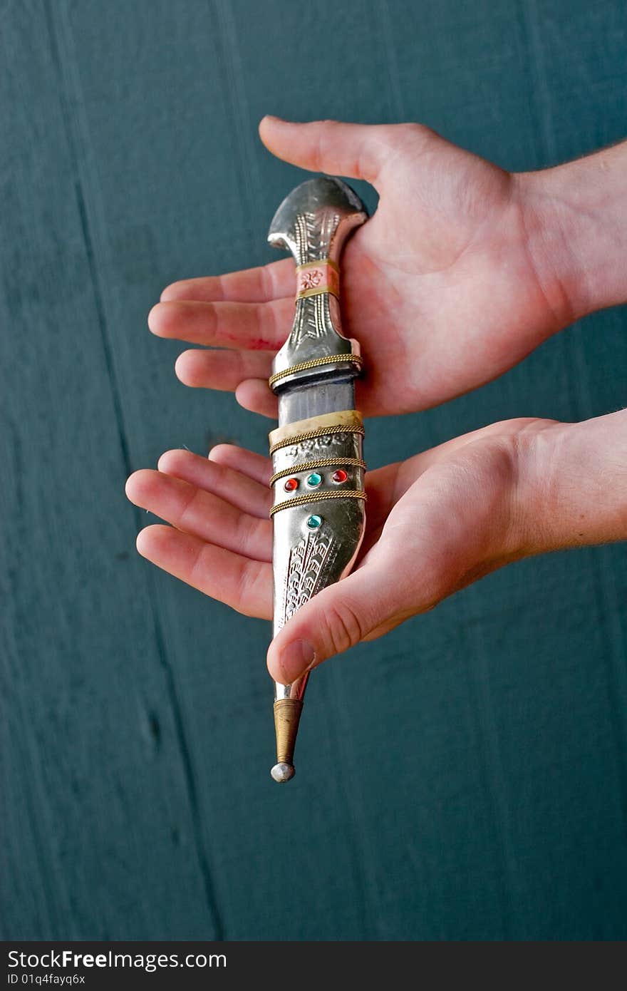 Hands holding   traditional Bedouin knife decorated with jewels
