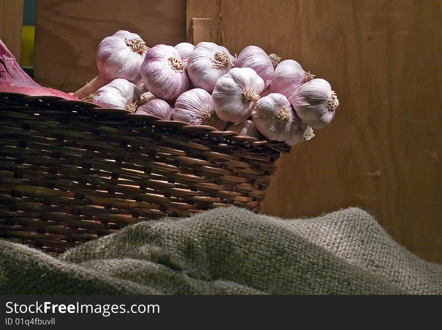 Bunch of young garlic in a wicker basket